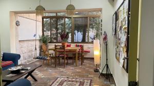 a living room with a table and a dining room at Darna Hostel in Amman
