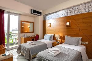 Postel nebo postele na pokoji v ubytování City Life Port Hotel