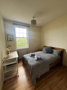 a bedroom with a bed and a table and a window at Edinburgh Centre - George Square Residence in Edinburgh