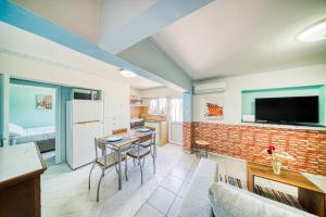 a kitchen and living room with a brick wall at MY ZEN Chios in Chios