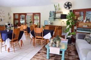 a living room with a couch and a table at Tengo guest house in Phalaborwa