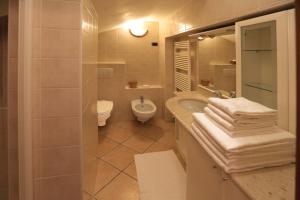 a bathroom with a sink and a toilet at North Wind Camping & Apartment in Domaso +131 photos