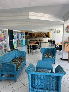 a restaurant with blue chairs and tables in a store at Marinas Vista Mar in Tamandaré +14 photos