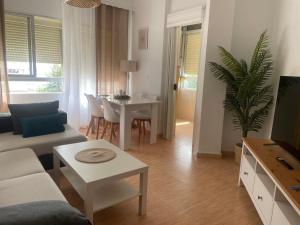 a living room with a couch and a table at Piso acogedor en Barbate in Barbate