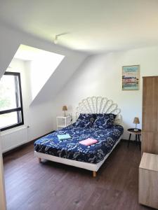a bedroom with a bed in a white room at Maison Saint Philibert 3 chambres in Saint-Philibert