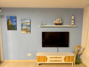 a living room with a flat screen tv on a wall at Petit Paradís in Sant Antoni de Calonge