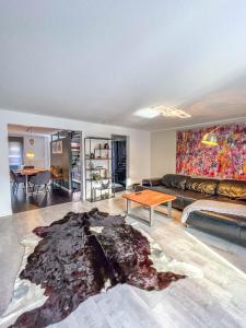a living room with a couch and a table at Modern Luxury Villa Antonia in Mössingen