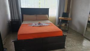 a bedroom with a bed with a tray on it at Tropical Crystal House in Guápiles