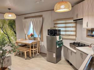 een keuken met een tafel en een koelkast. bij Dodam 1070 in Busan