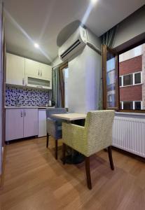 a kitchen with a table and chairs in a room at Mitra Downtown Hotel in Istanbul