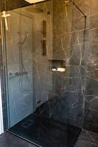 a bathroom with a shower with a glass door at Fenili Belasi - apartamento nuovo in Castel Mella +13 photos