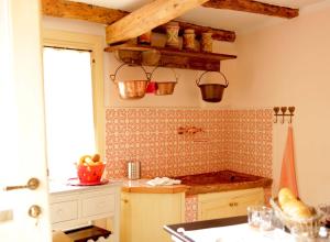 a kitchen with a sink and a counter with buckets at Ca' Boschetto in Bassano del Grappa