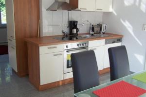 a small kitchen with a stove and a sink at Carodorfblick in Carolinensiel