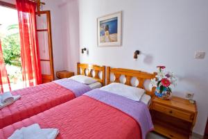 A bed or beds in a room at Skiathos House