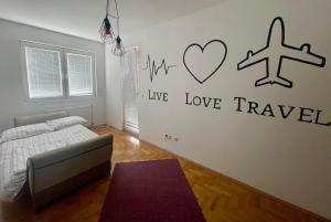 a bedroom with a bed and a writing on the wall at CRooms in Peje
