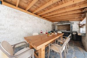 a dining room with a wooden table and chairs at Villa Blue Haven in Ulcinj