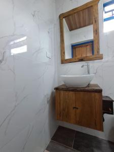 a bathroom with a sink and a mirror at El Guaney Campestre in Somondoco