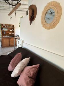 a room with a couch with pillows and a mirror at PataGo! Sea&Sand in Playa Unión