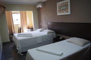 Posteľ alebo postele v izbe v ubytovaní Candango Aero Hotel