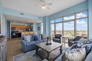 a living room with couches and a table at Sea it All Infinity pool ocean views steps from the beach - a perfect romantic getaway in Galveston