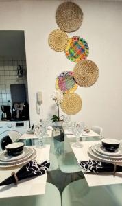 a kitchen with a glass table with plates on it at Ap 509 Ed Santorini Ponta Verde in Maceió
