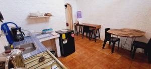 a kitchen with a table and a small refrigerator at Cabañas Don Jorge - Cabaña Fragata in Puerto Baquerizo Moreno