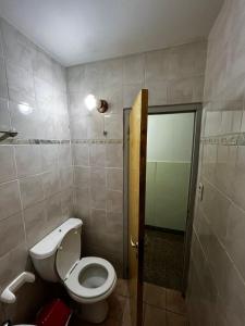 a small bathroom with a toilet and a shower at Hotel Residencial Independencia in San Rafael