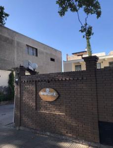 a brick wall with a sign on it at Hotel Residencial Independencia in San Rafael +4 photos