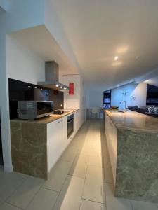 a large kitchen with a counter top and a stove at St Falls Penthouse Apartment E602 in Falls Creek +7 photos