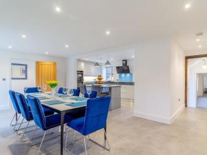 a dining room with a table and blue chairs at Skylark Barn-Uk31354 in Swaffham +23 photos