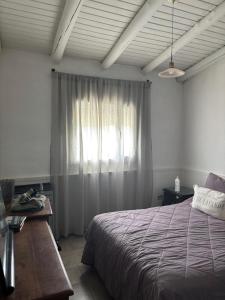 a bedroom with a bed and a window at PataGo! Sea&Sand in Playa Unión +32 photos