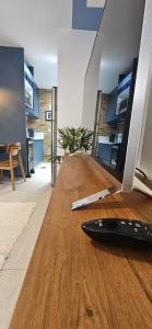 a surfboard sitting on the floor of a living room at Um lugar de charme e aconchego - Rosa! in Brasília