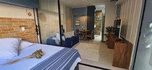 a hotel room with a bed and a dining room at Um lugar de charme e aconchego - Rosa! in Brasília