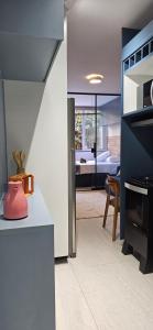 a kitchen with a dining room and a bedroom at Um lugar de charme e aconchego - Rosa! in Brasília