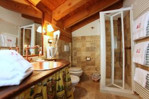 a bathroom with a sink and a shower and a toilet at Eco Chalet Maison Dominique in Challand Saint Anselme