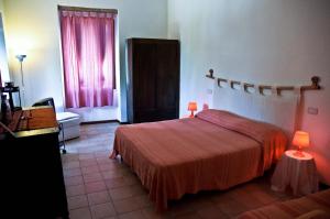 a hotel room with a bed and a window at Sentieri Luminosi in SantʼAgata deʼ Goti