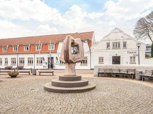 a statue in the middle of a courtyard with buildings at 4 person holiday park home in Give in Give
