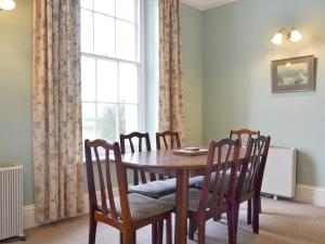 a dining room with a table and chairs and a window at Apartment 3-Uk33247 in Grayrigg +23 photos