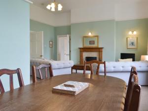 a dining room with a table and a couch at Apartment 3-Uk33247 in Grayrigg