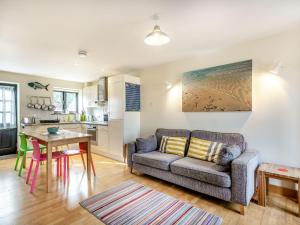 a living room with a couch and a table at Crab Cottage in Wells next the Sea