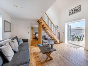 a living room with a couch and a table at Ty Godro - Uk12745 in Acrefair