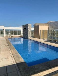 a swimming pool on the roof of a building at Quarto em Ap no Renascença in São Luís