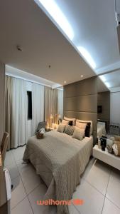 a bedroom with a large bed in a room at Suite em Belo Horizonte com Vista e Piscina in Belo Horizonte