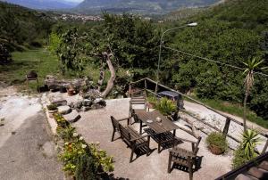 a picnic table and chairs with a view of a mountain at Sentieri Luminosi in SantʼAgata deʼ Goti
