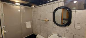 a bathroom with a mirror and a sink and a toilet at Hotel San Francisco INN in Arequipa +17 photos