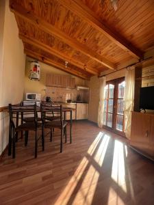 a kitchen with a table and chairs in a room at Las Dolinas 3 in Malargüe