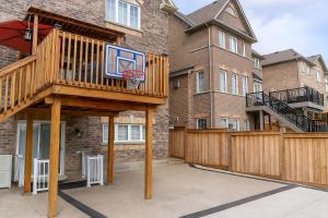 a basketball hoop in the courtyard of a building at Cozy 3BR Caledon Basement Suite with Private Access, Backyard Basketball Court, Full Kitchen, WiFi, Laundry, 5 Mins to Brampton, Family Friendly, Near Trails & Parks! in Caledon