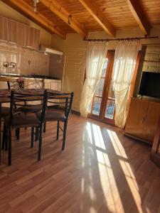a dining room with a table with chairs and a television at Las Dolinas 3 in Malargüe