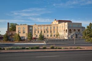 a large building on the side of a road at Hotel Parq Central Albuquerque in Albuquerque