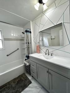 a bathroom with a sink and a mirror at Family-Friendly Home Near Sesame Place 2 King Beds in Morrisville